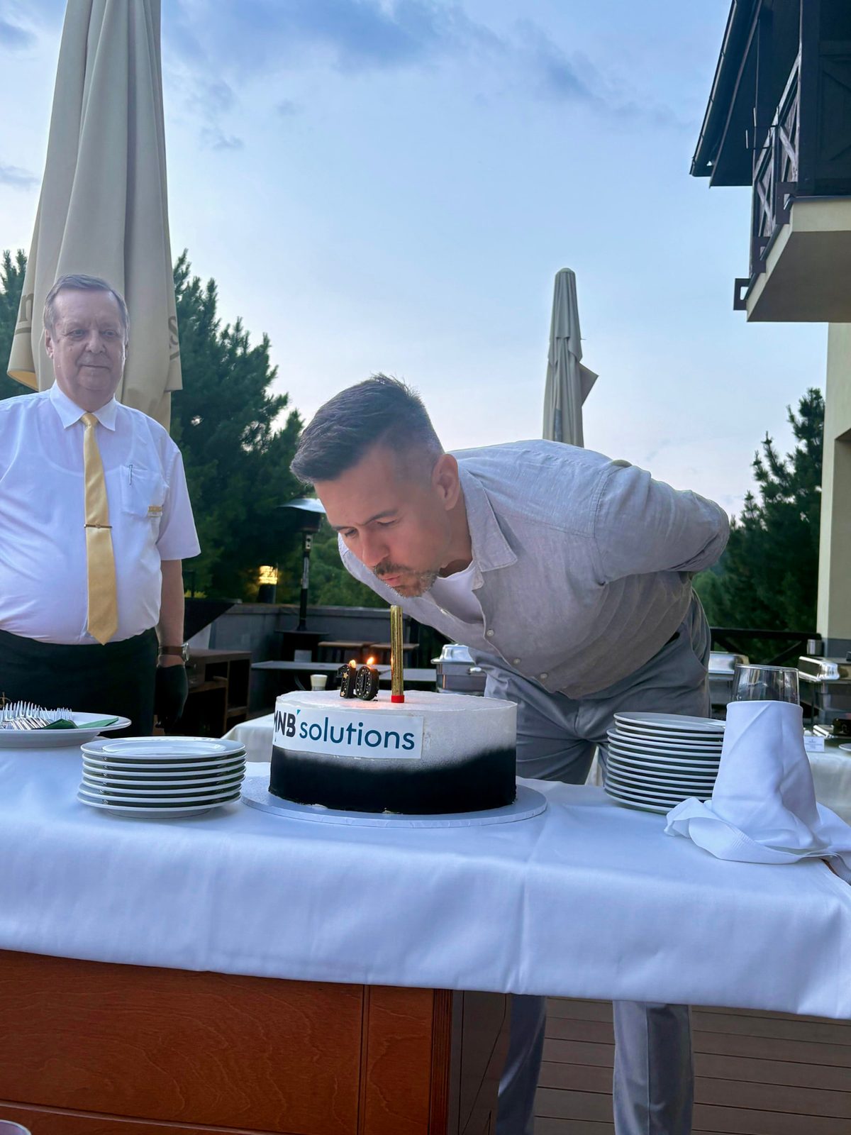 Blowing out the candles on the MNB Solutions 10-year anniversary cake